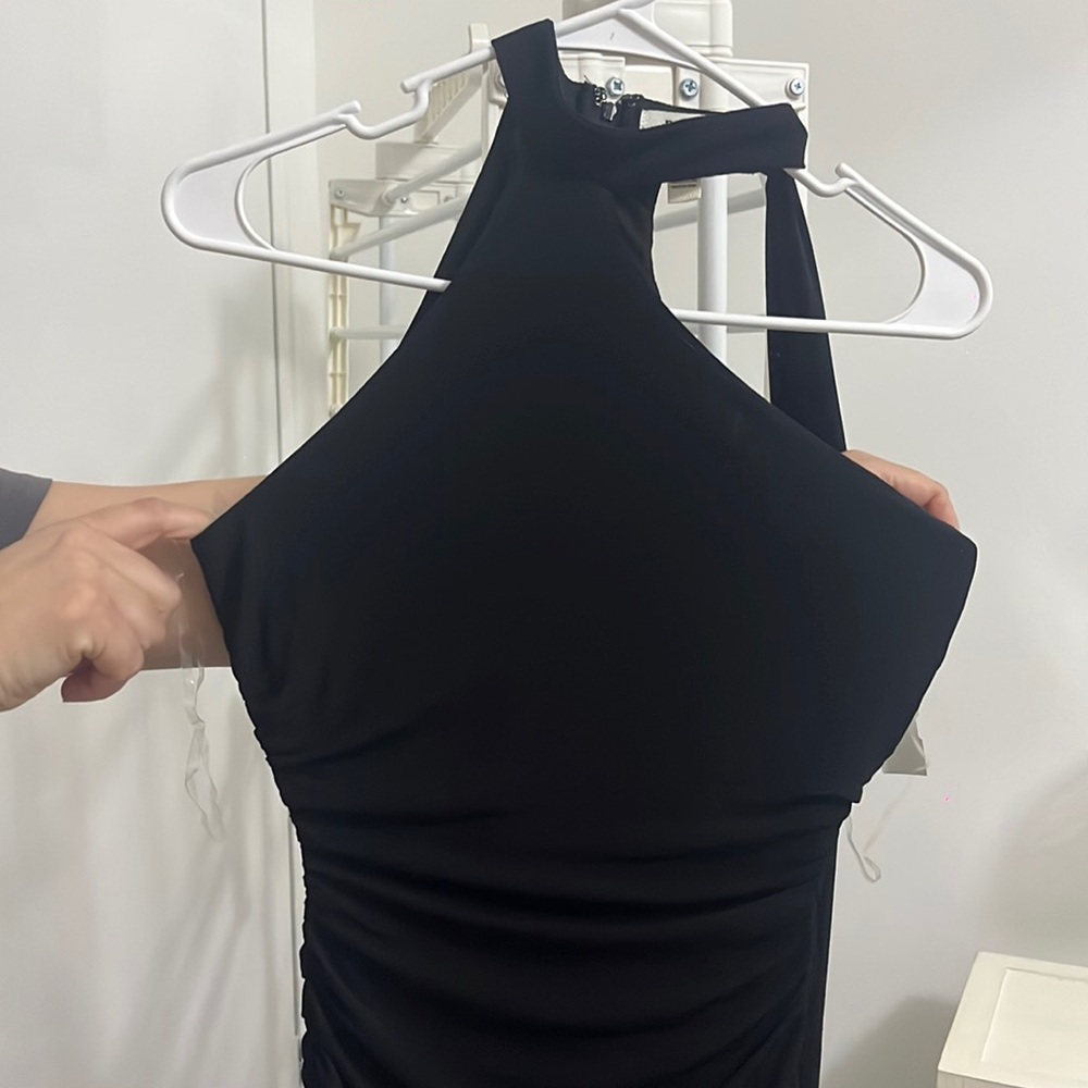 Black mesh material dress with drape.